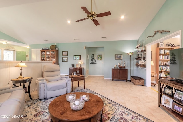 tiled living room featuring ceiling fan and high vaulted ceiling