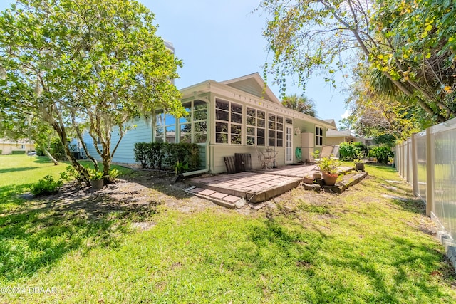 back of house with a lawn and a patio