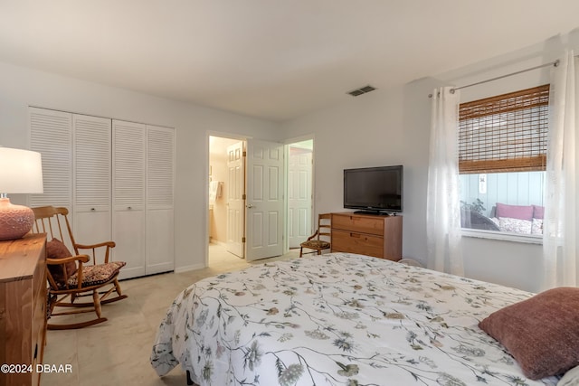 bedroom featuring connected bathroom and a closet