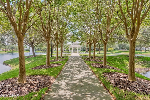 view of home's community with a gazebo, a water view, and a yard