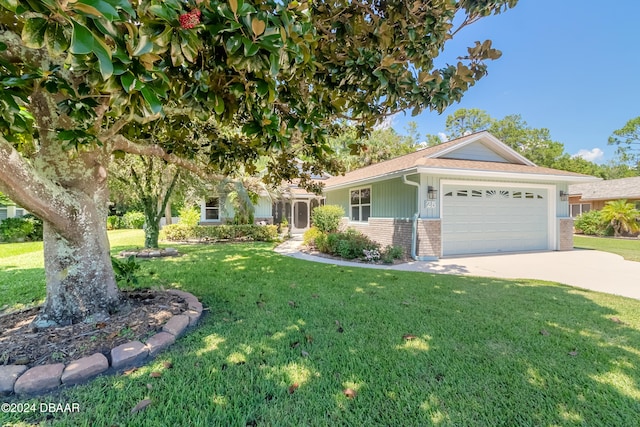 view of front facade with a garage and a front lawn