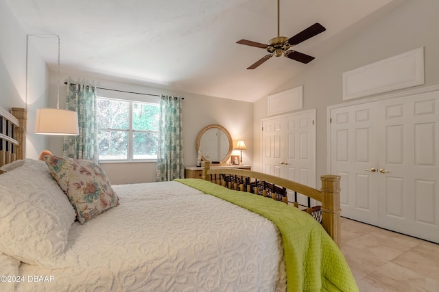 bedroom with ceiling fan, high vaulted ceiling, and multiple closets