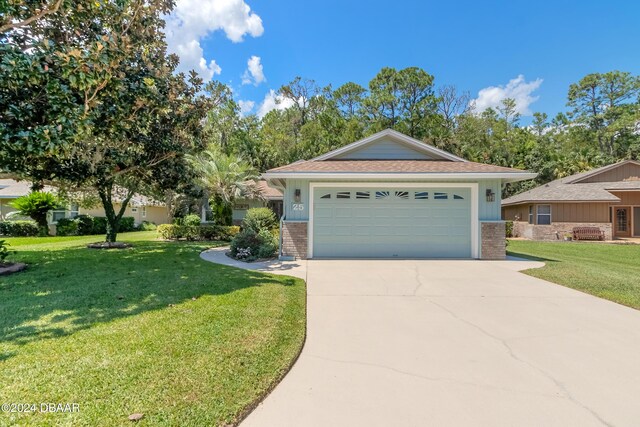 view of front of property featuring a front yard and a garage