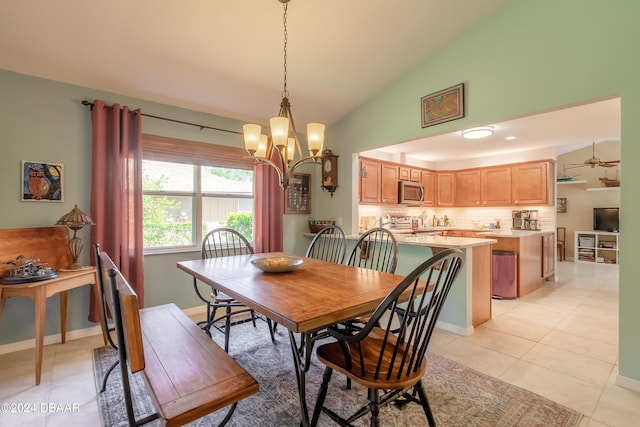 dining room featuring light tile patterned flooring, ceiling fan with notable chandelier, and high vaulted ceiling