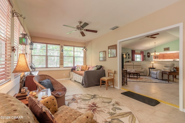 living room featuring ceiling fan, light tile patterned flooring, and vaulted ceiling