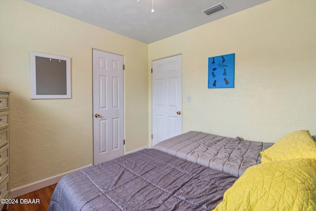 bedroom with hardwood / wood-style floors