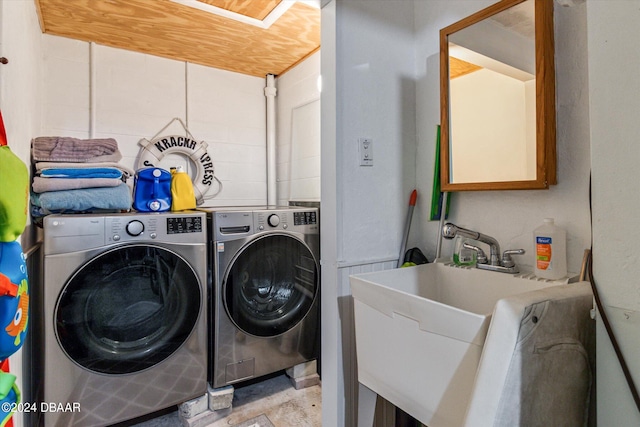 washroom with washer and dryer and sink