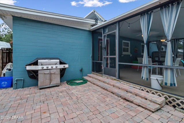 view of patio featuring grilling area and a sunroom