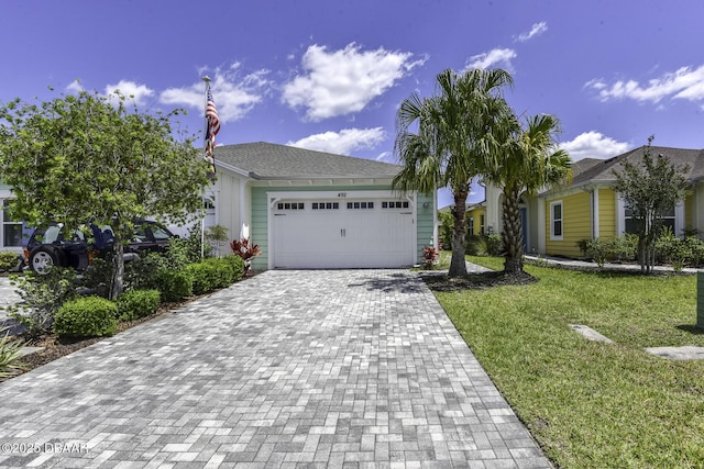 view of front facade with a front yard and a garage