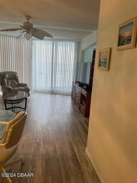 living room featuring hardwood / wood-style floors, ceiling fan, and beam ceiling