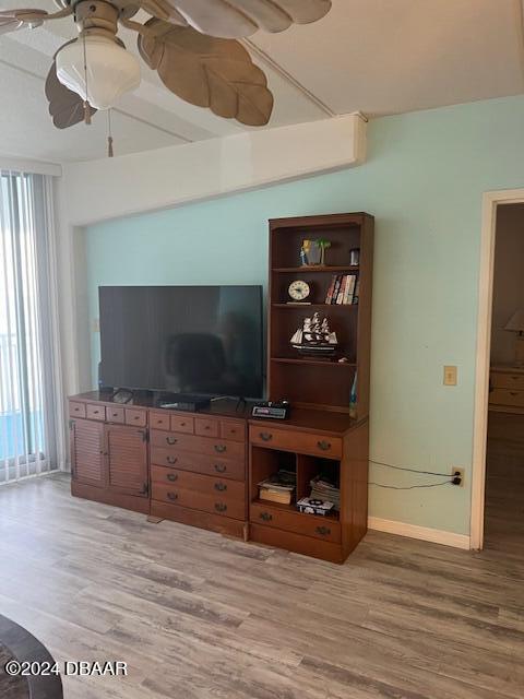 living room featuring hardwood / wood-style flooring and ceiling fan