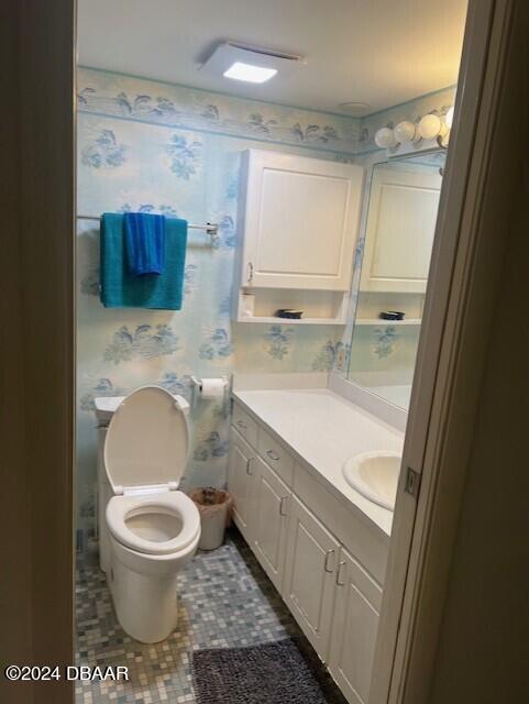 bathroom with tile patterned flooring, vanity, and toilet