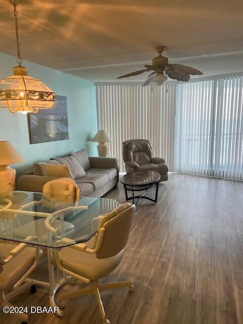 living room featuring hardwood / wood-style flooring and ceiling fan