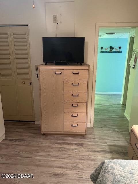 bedroom with a closet and light hardwood / wood-style floors