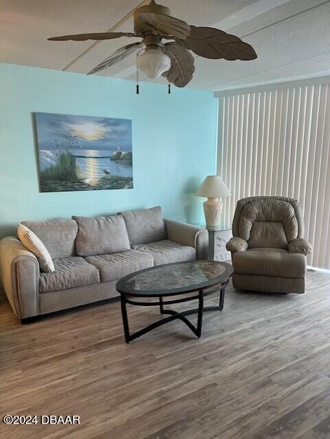 living room featuring hardwood / wood-style flooring and ceiling fan