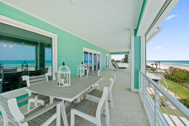 balcony featuring a beach view and a water view