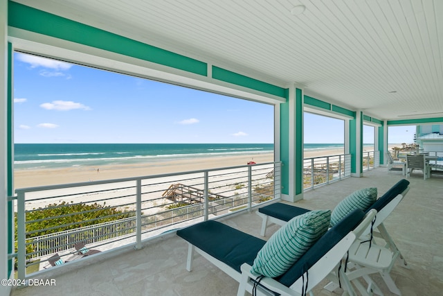 balcony with a beach view and a water view