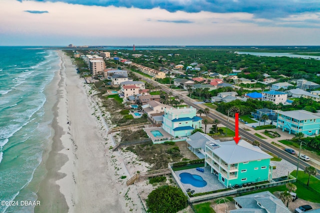 drone / aerial view featuring a water view and a beach view