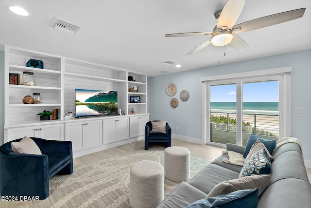 living room featuring light hardwood / wood-style floors and ceiling fan