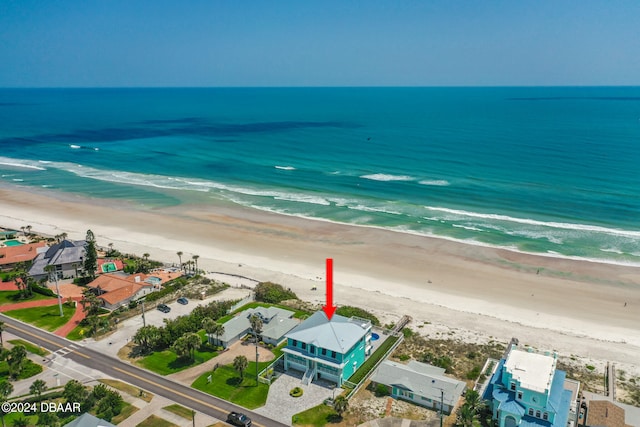 birds eye view of property featuring a view of the beach and a water view