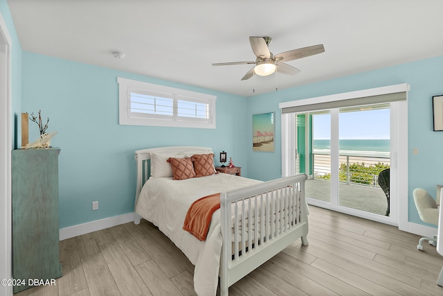 bedroom with access to outside, a water view, ceiling fan, and light hardwood / wood-style flooring