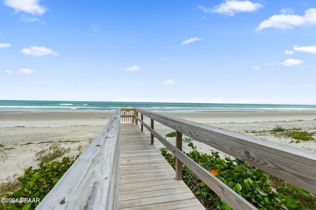 exterior space featuring a beach view and a water view