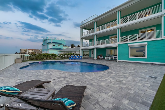 view of pool with a patio and pool water feature