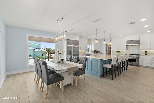 dining space with light hardwood / wood-style flooring