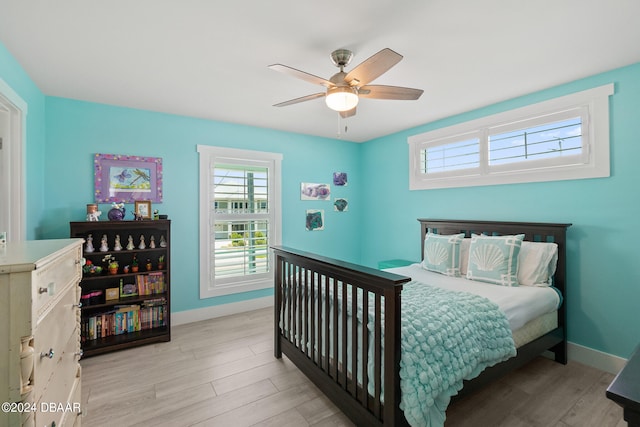 bedroom with light hardwood / wood-style flooring and ceiling fan