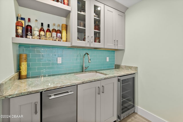 bar with wine cooler, sink, tasteful backsplash, light stone countertops, and dishwasher