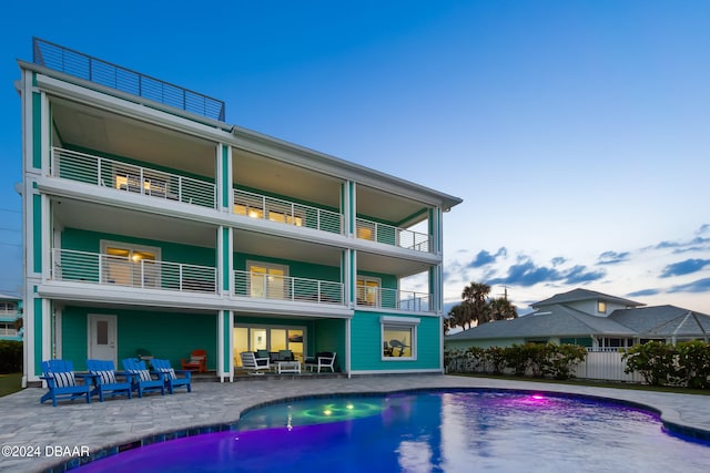 rear view of house with a balcony and a patio area