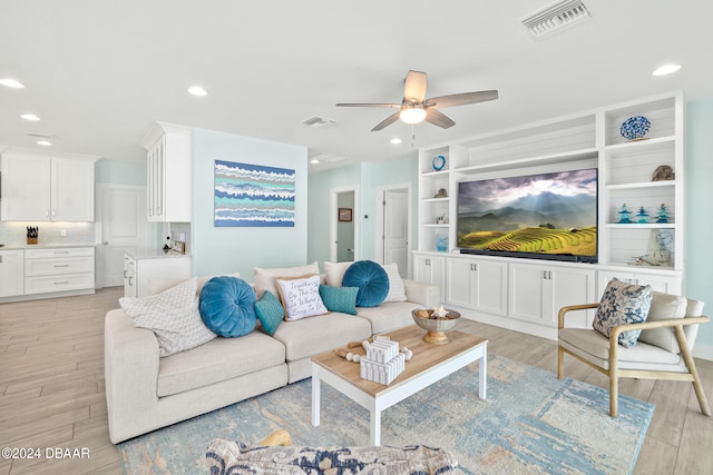 living room featuring light hardwood / wood-style floors and ceiling fan