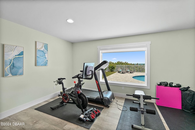 workout area with light hardwood / wood-style floors