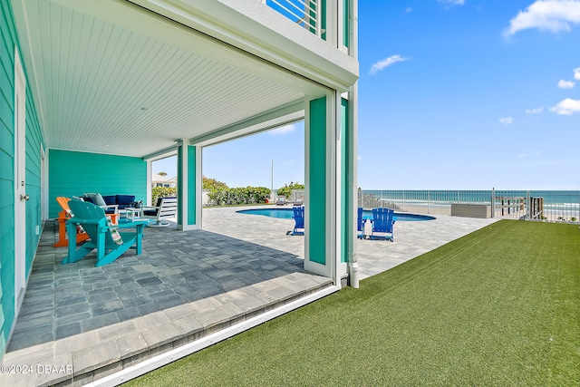 view of patio / terrace featuring a fenced in pool and a water view