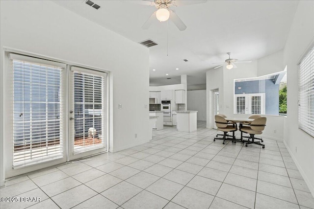 49 Ludlow Ln W W, Unit W, Palm Coast, FL 32137 - dining area with ceiling fan, light tile patterned flooring, and baseboards