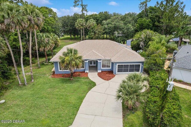 49 Ludlow Ln W W, Unit W, Palm Coast, FL 32137 - view of front facade featuring an attached garage, concrete driveway, a front lawn, french doors, and a chimney