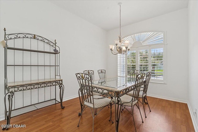 49 Ludlow Ln W W, Unit W, Palm Coast, FL 32137 - dining room featuring a chandelier, wood finished floors, and baseboards