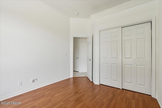 49 Ludlow Ln W W, Unit W, Palm Coast, FL 32137 - unfurnished bedroom with light wood-style floors, baseboards, and a closet