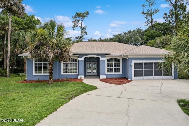 49 Ludlow Ln W W, Unit W, Palm Coast, FL 32137 - single story home featuring french doors, an attached garage, driveway, stucco siding, and a front yard