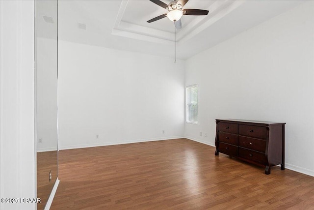 49 Ludlow Ln W W, Unit W, Palm Coast, FL 32137 - spare room featuring ceiling fan, a tray ceiling, wood finished floors, and baseboards