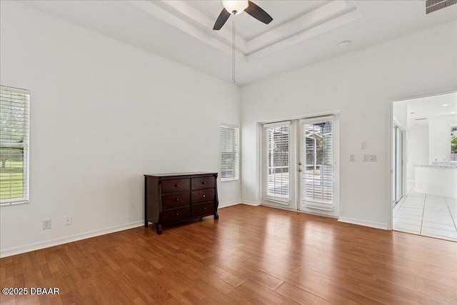 49 Ludlow Ln W W, Unit W, Palm Coast, FL 32137 - empty room featuring french doors, wood finished floors, a ceiling fan, and a towering ceiling