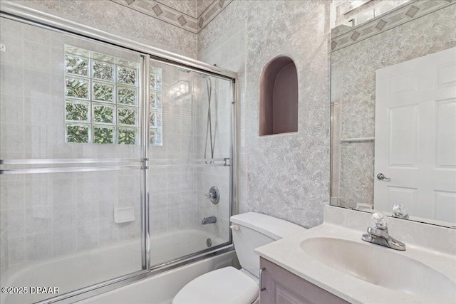 49 Ludlow Ln W W, Unit W, Palm Coast, FL 32137 - full bathroom featuring vanity, toilet, and shower / bath combination with glass door