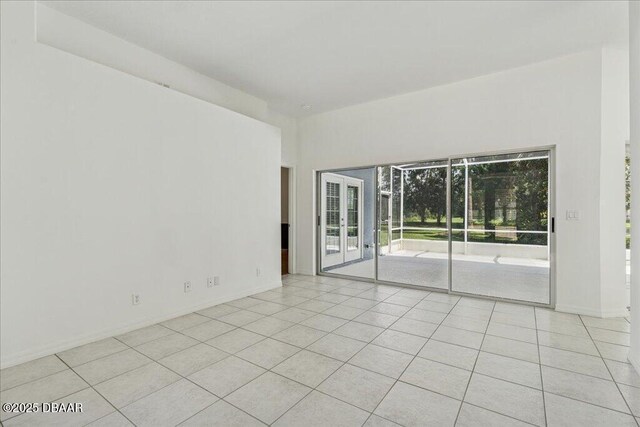 49 Ludlow Ln W W, Unit W, Palm Coast, FL 32137 - empty room with light tile patterned floors and baseboards