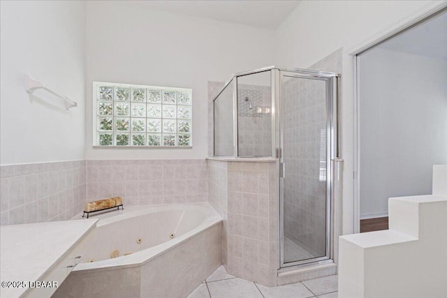 49 Ludlow Ln W W, Unit W, Palm Coast, FL 32137 - bathroom featuring a stall shower, a whirlpool tub, and tile patterned floors