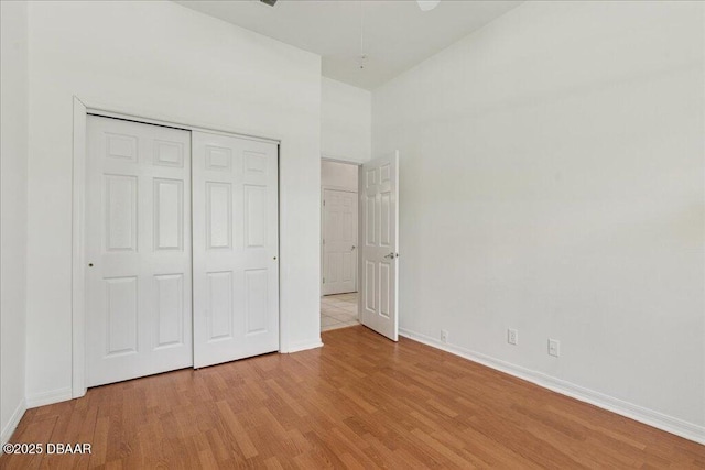 49 Ludlow Ln W W, Unit W, Palm Coast, FL 32137 - unfurnished bedroom with light wood finished floors, baseboards, and a closet