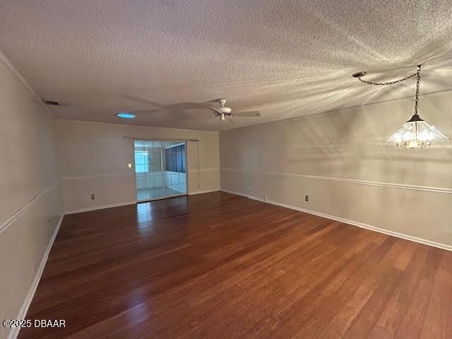 6 Stymie Ln, New Smyrna Beach, FL 32168 - spare room with a textured ceiling, wood finished floors, baseboards, and ceiling fan