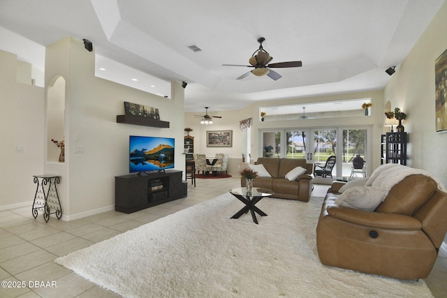 2141 Springwater Ln, Port Orange, FL 32128 - living room with ceiling fan, tile patterned flooring, arched walkways, and a tray ceiling