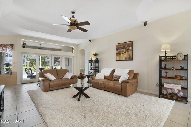 2141 Springwater Ln, Port Orange, FL 32128 - living area featuring light tile patterned flooring, ceiling fan, arched walkways, and french doors