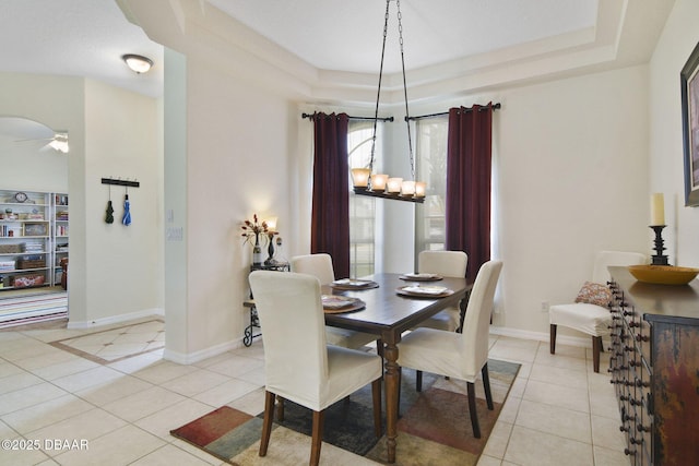 2141 Springwater Ln, Port Orange, FL 32128 - dining space with a tray ceiling, light tile patterned floors, and a ceiling fan