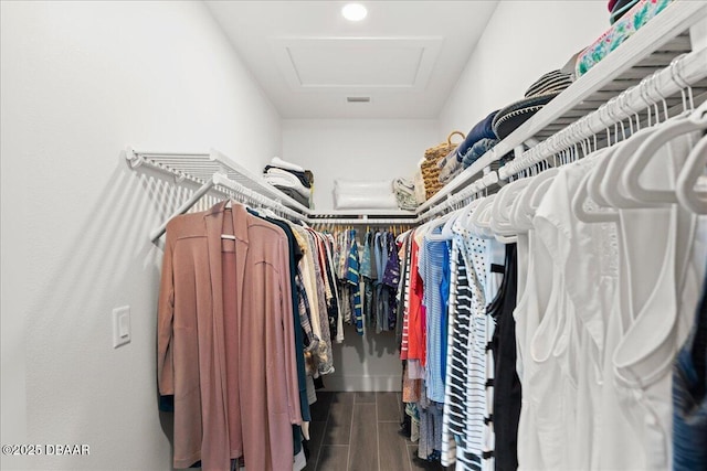 spacious closet featuring attic access